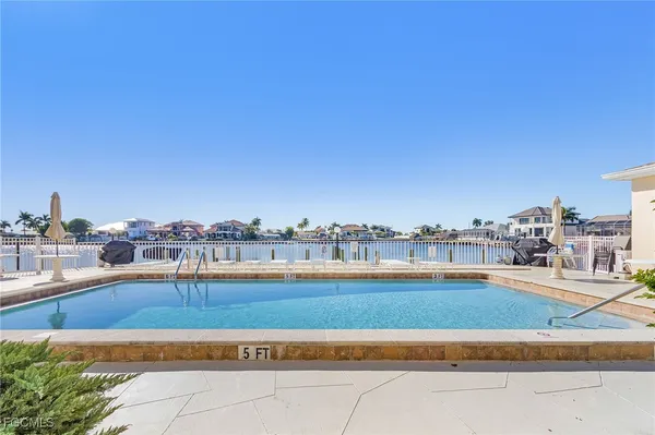 a view of swimming pool with outdoor seating and city view