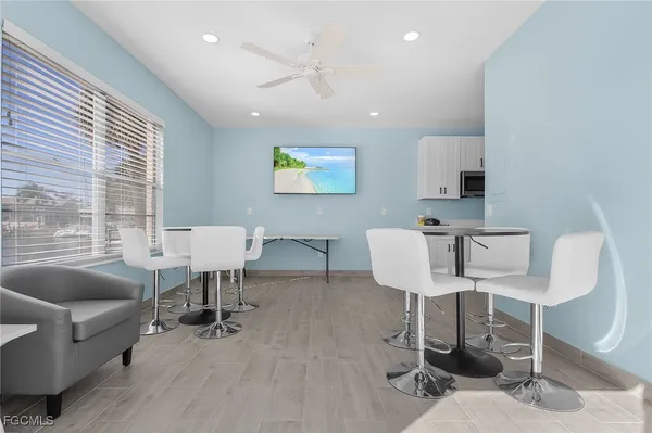 a view of a livingroom with furniture and a large window