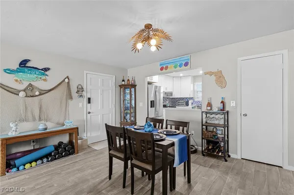 a dining room with a wooden table and chairs