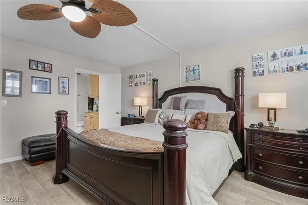 a bedroom with a bed and lamp on the dresser