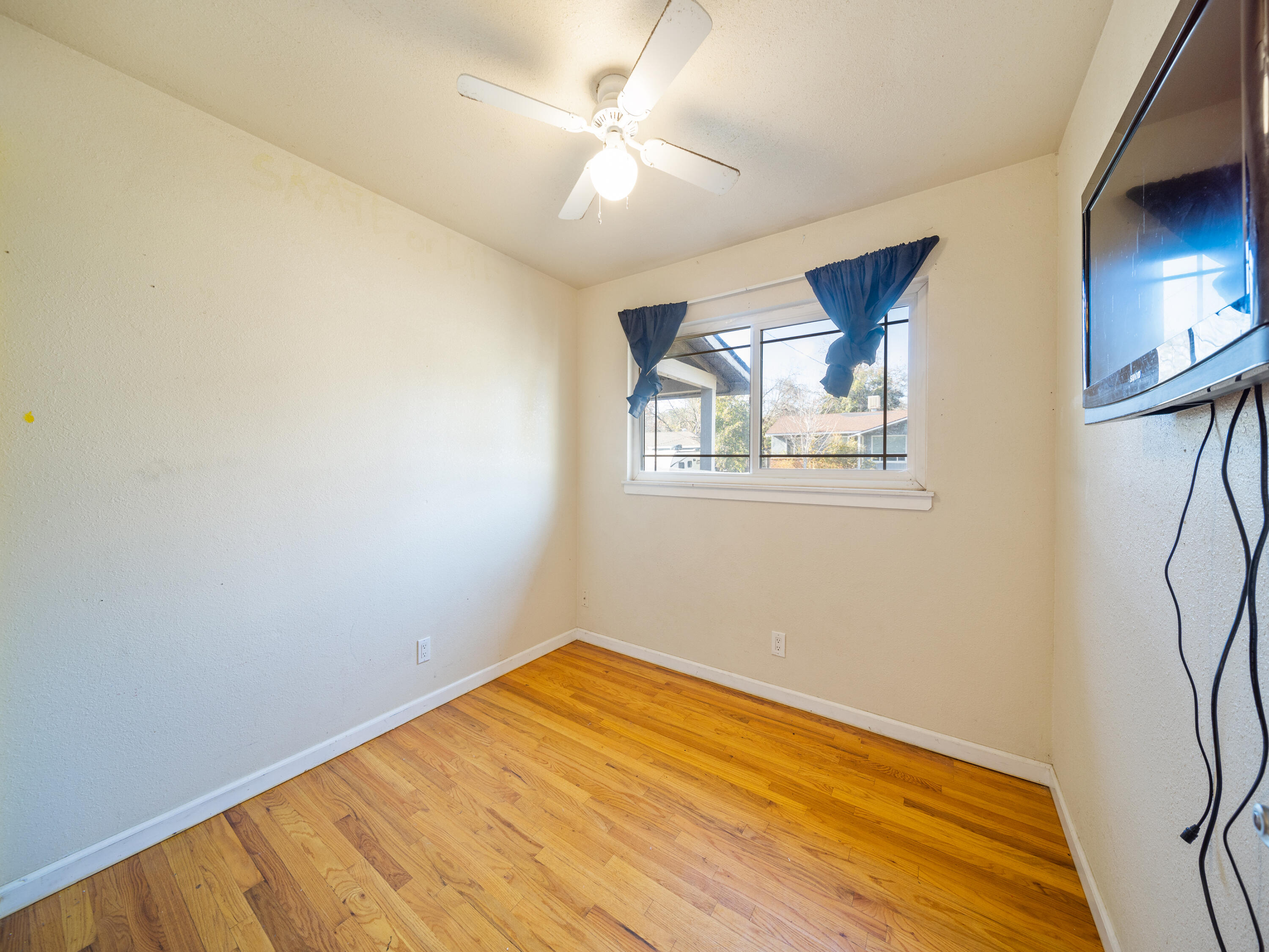 2921 West Way Redding, CA 96002 - Photo 13 of 36 a view of empty room with wooden floor and fan