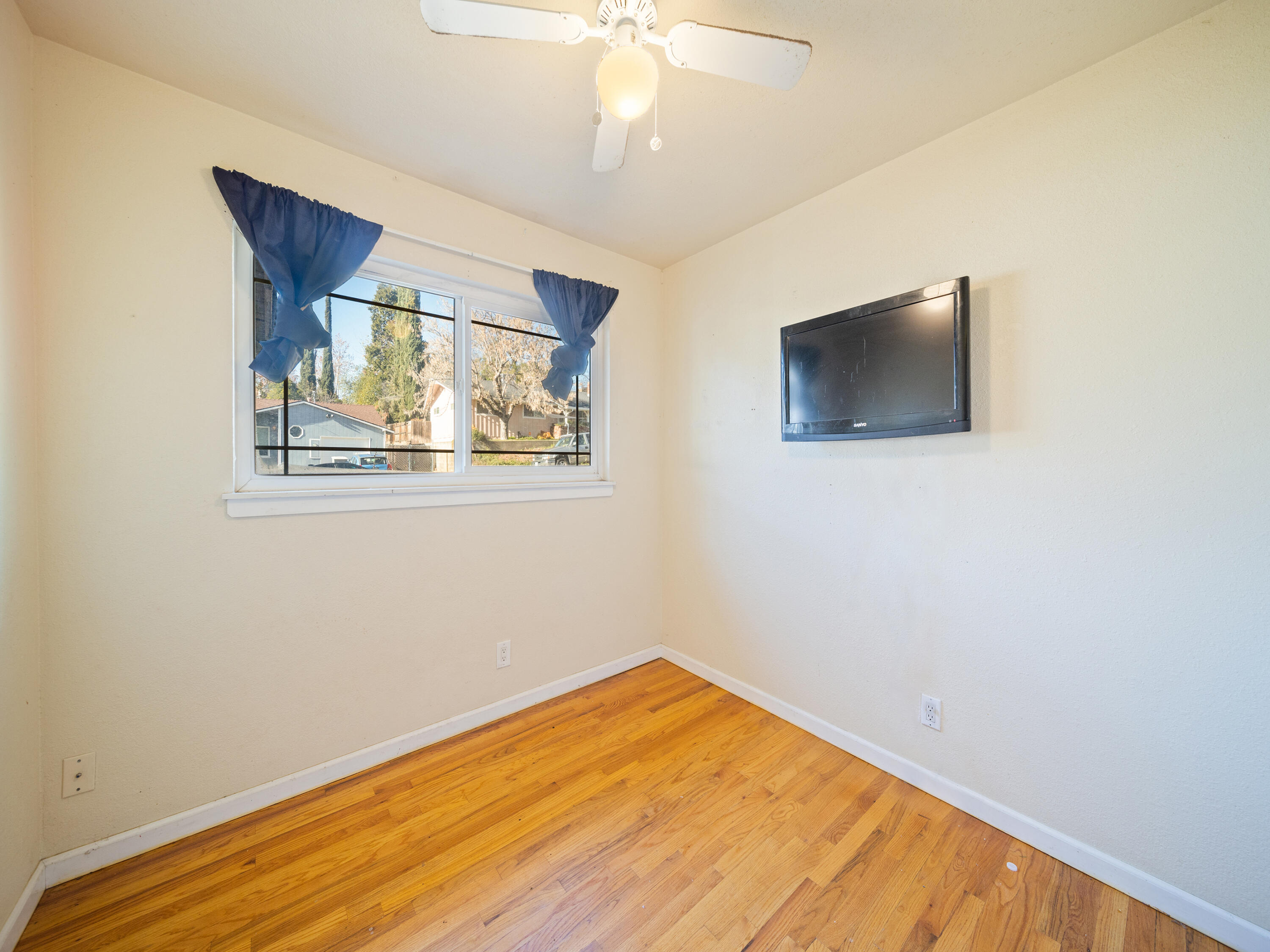 2921 West Way Redding, CA 96002 - Photo 14 of 36 a view of an empty room with wooden floor and a window