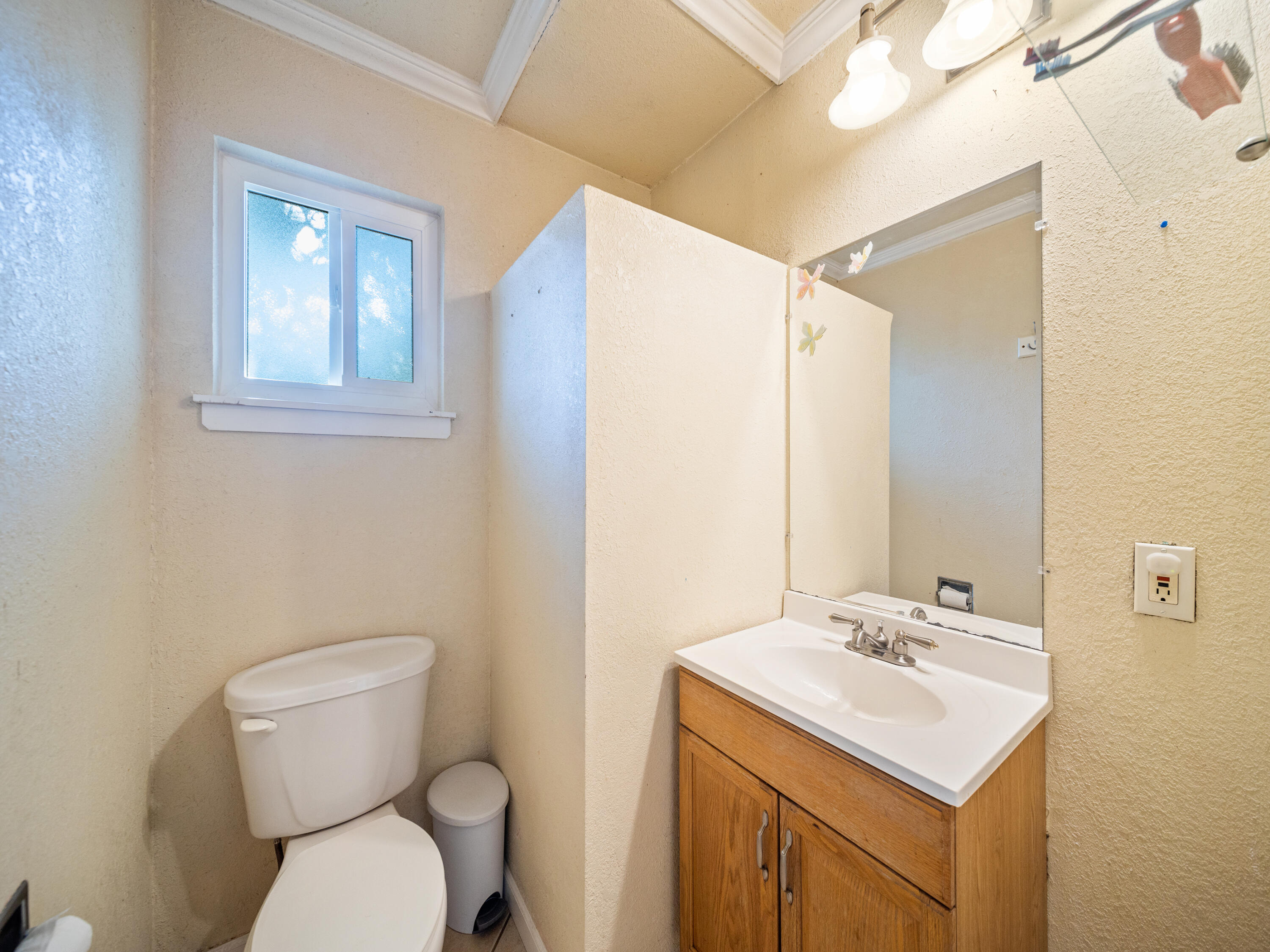 2921 West Way Redding, CA 96002 - Photo 15 of 36 a bathroom with a toilet sink and mirror