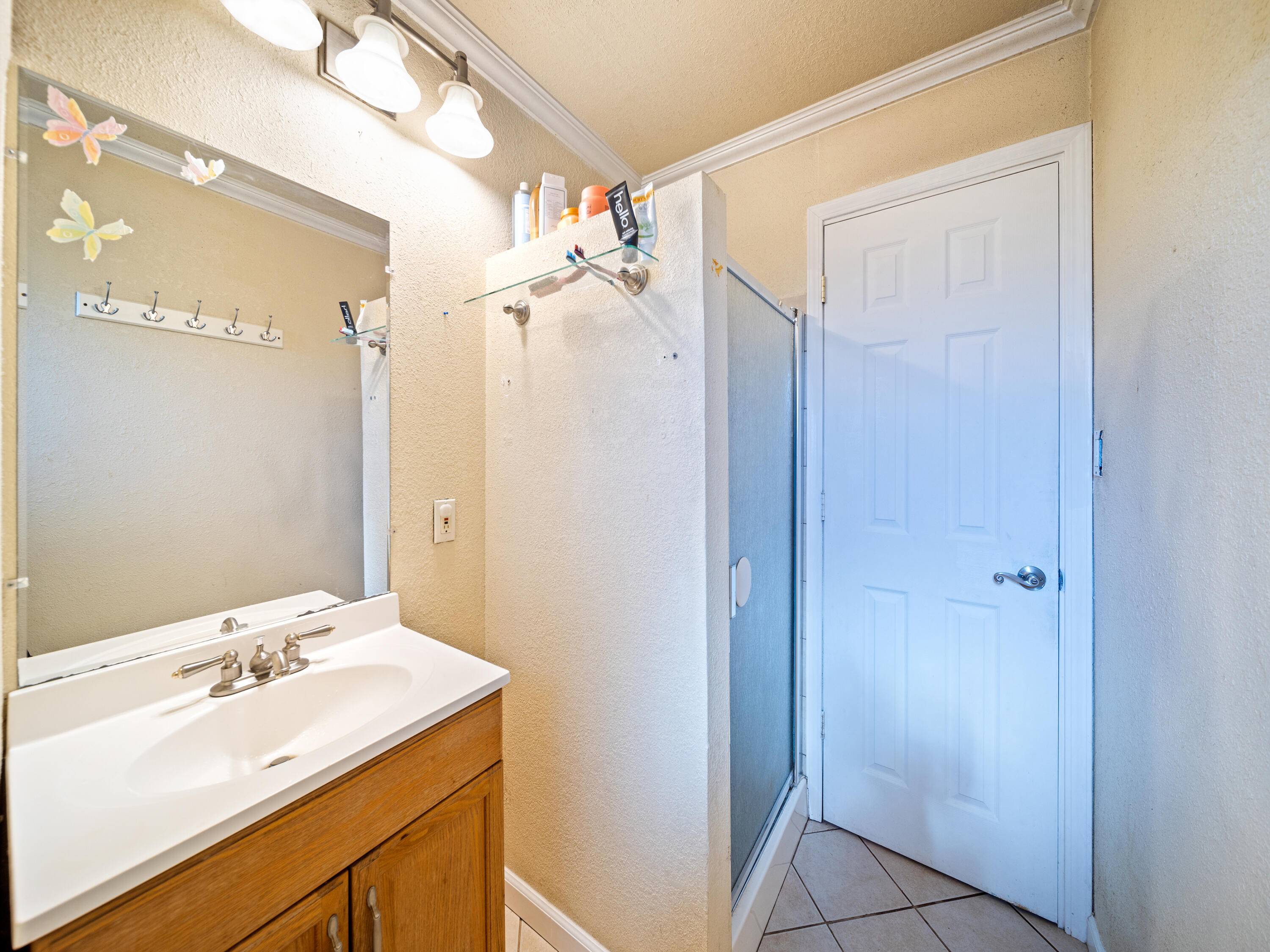 2921 West Way Redding, CA 96002 - Photo 16 of 36 a bathroom with a shower sink vanity and mirror