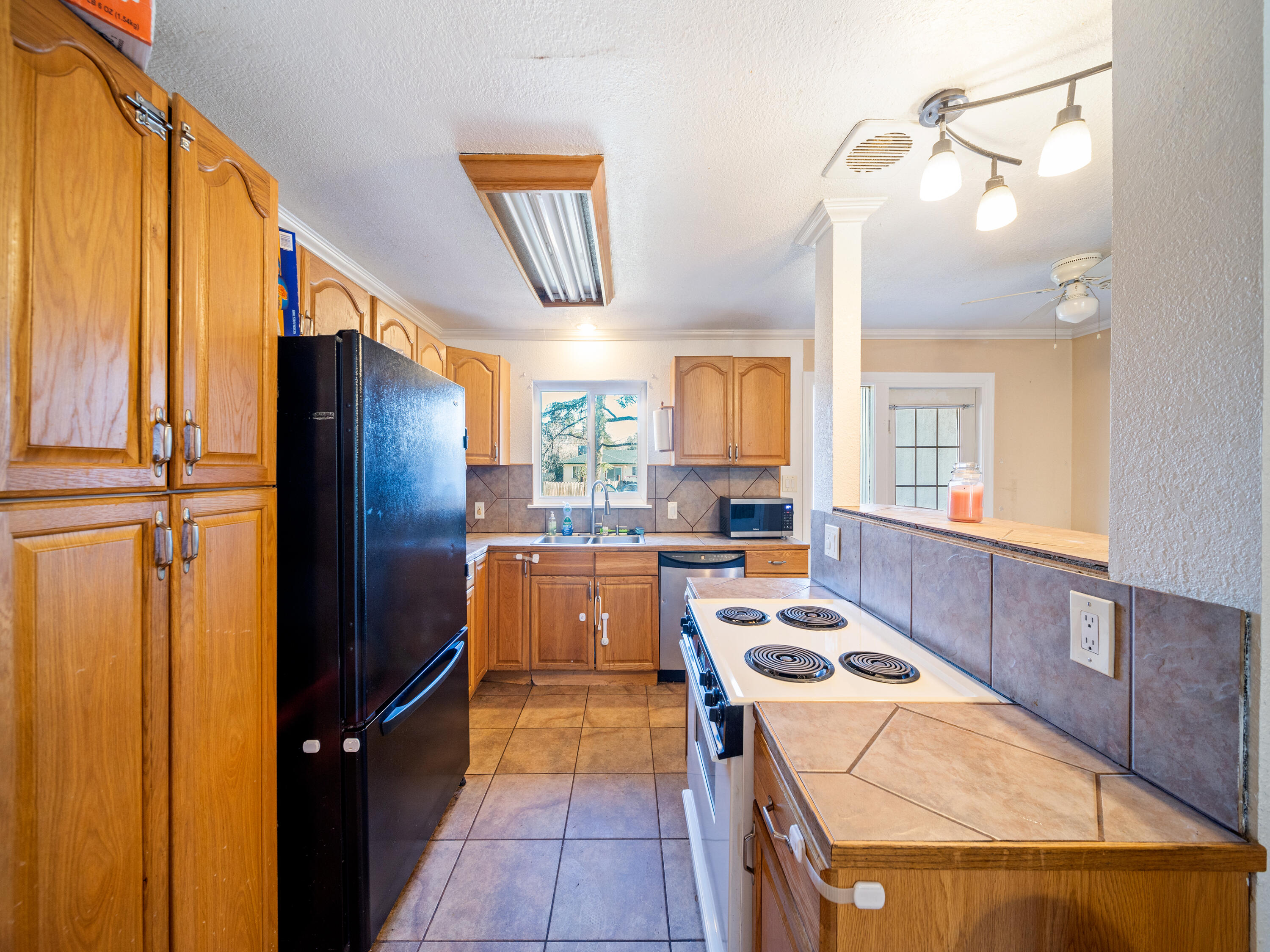 2921 West Way Redding, CA 96002 - Photo 6 of 36 a kitchen with stainless steel appliances granite countertop a refrigerator and a stove top oven