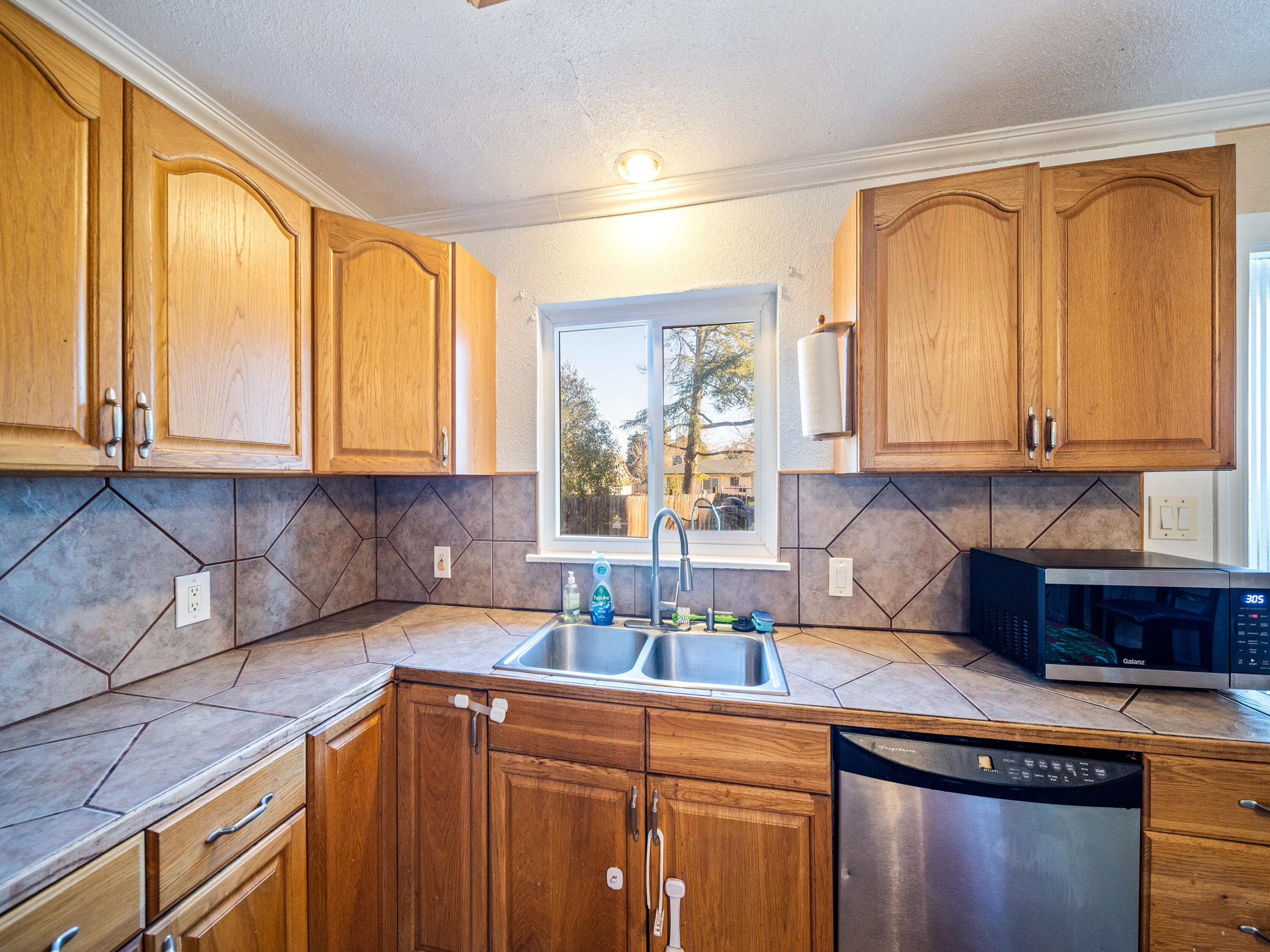 2921 West Way Redding, CA 96002 - Photo 8 of 36 a kitchen with stainless steel appliances granite countertop sink stove and cabinets