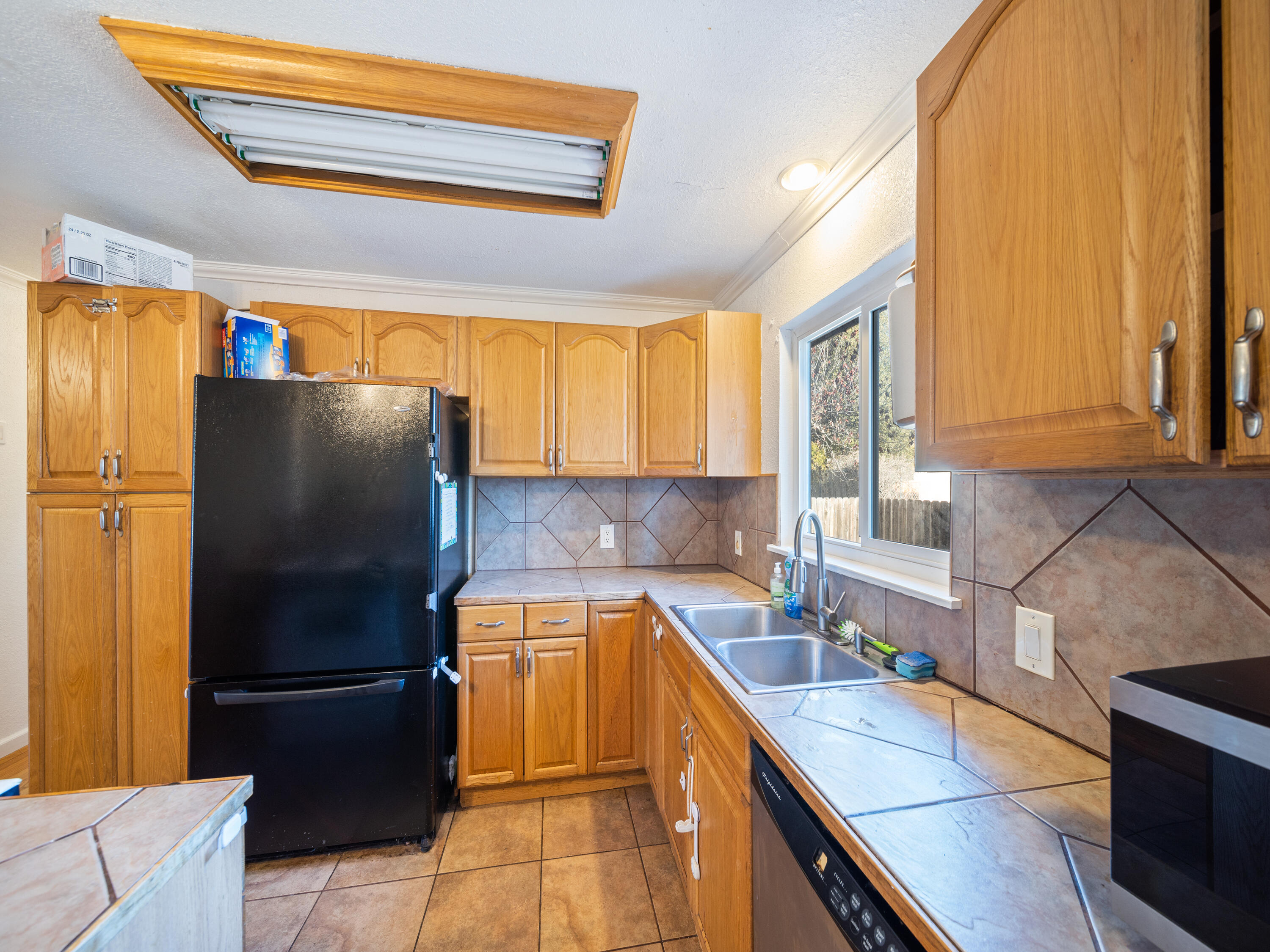 2921 West Way Redding, CA 96002 - Photo 9 of 36 a kitchen with a refrigerator and a sink