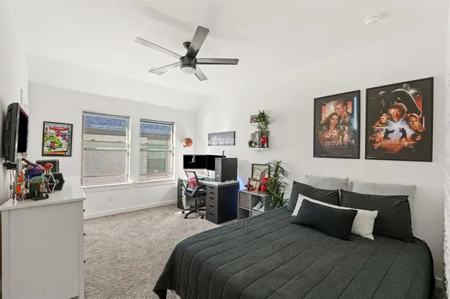 a bedroom with furniture and a large window