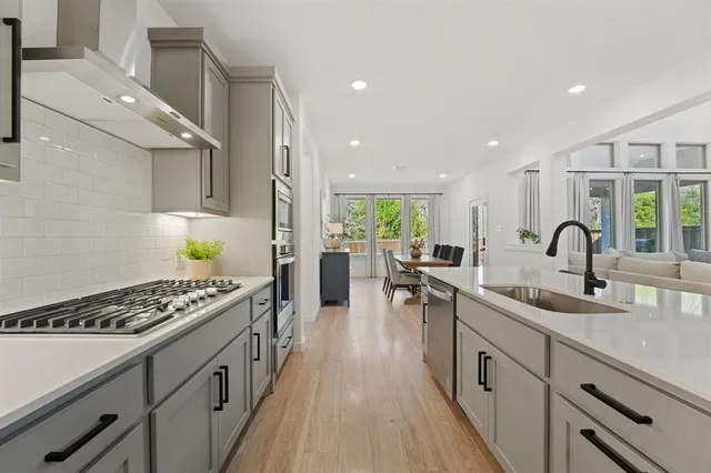 a kitchen with counter top space a sink stainless steel appliances and cabinets