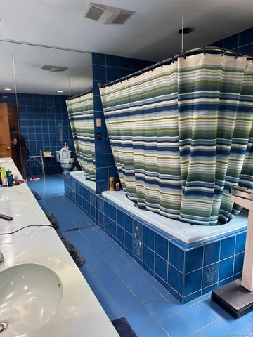 a kitchen with a refrigerator and a sink