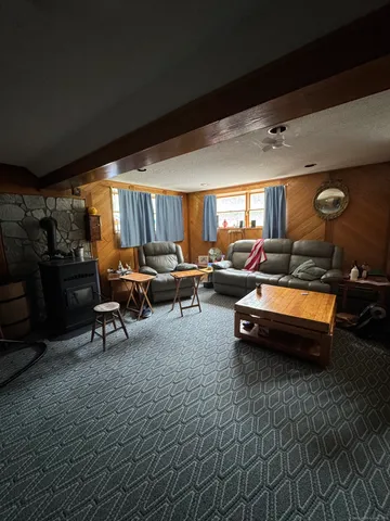 a living room with furniture a window and a flat screen tv