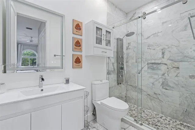 an aerial view of residential houses with outdoor space and lake view