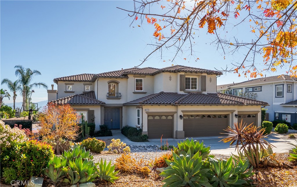 9669 Norbrook Drive Rancho Cucamonga, CA 91737 - Photo 2 of 47 a front view of a house with a yard and potted plants