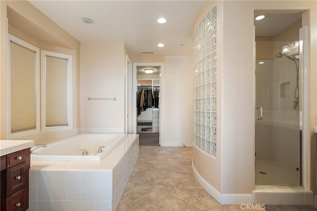 9669 Norbrook Drive Rancho Cucamonga, CA 91737 - Photo 27 of 47 a bathroom with a sink a mirror and a shower