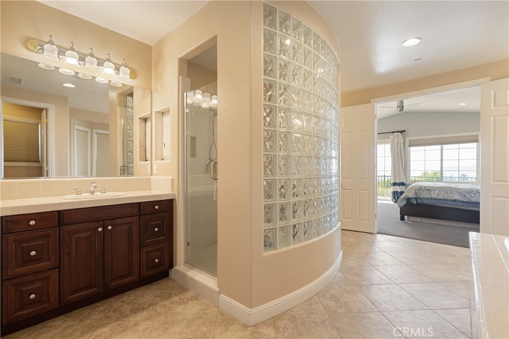 9669 Norbrook Drive Rancho Cucamonga, CA 91737 - Photo 28 of 47 a spacious bathroom with a shower sink and mirror