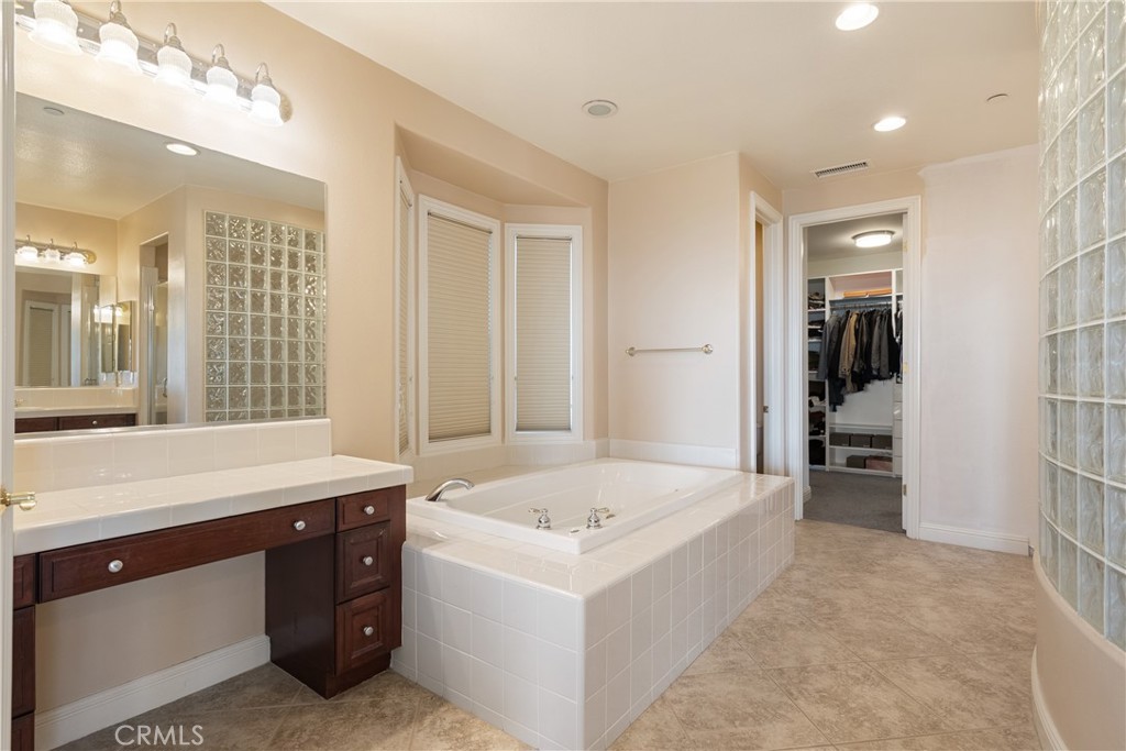 9669 Norbrook Drive Rancho Cucamonga, CA 91737 - Photo 29 of 47 a spacious bathroom with a tub sink and mirror