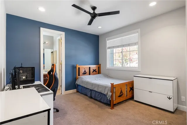 a bedroom with a bed a dresser and a window