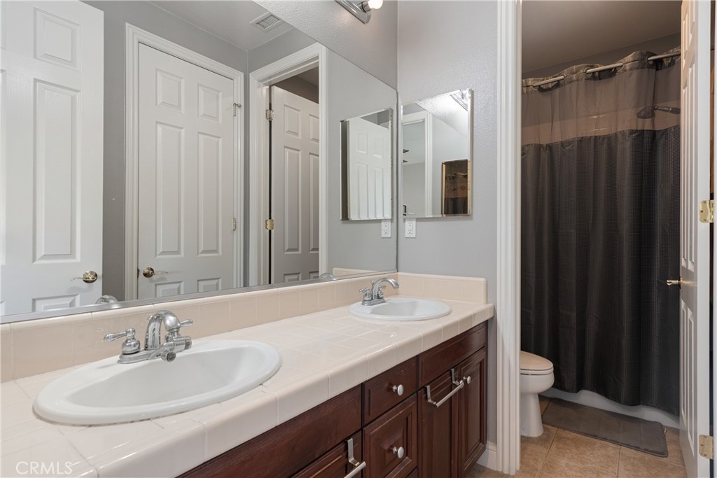 9669 Norbrook Drive Rancho Cucamonga, CA 91737 - Photo 33 of 47 a bathroom with a double vanity sink mirror and double