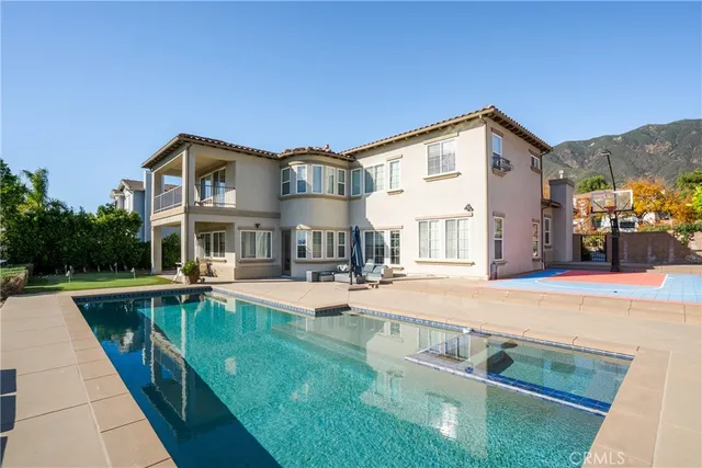 a view of a house with sitting area and swimming pool