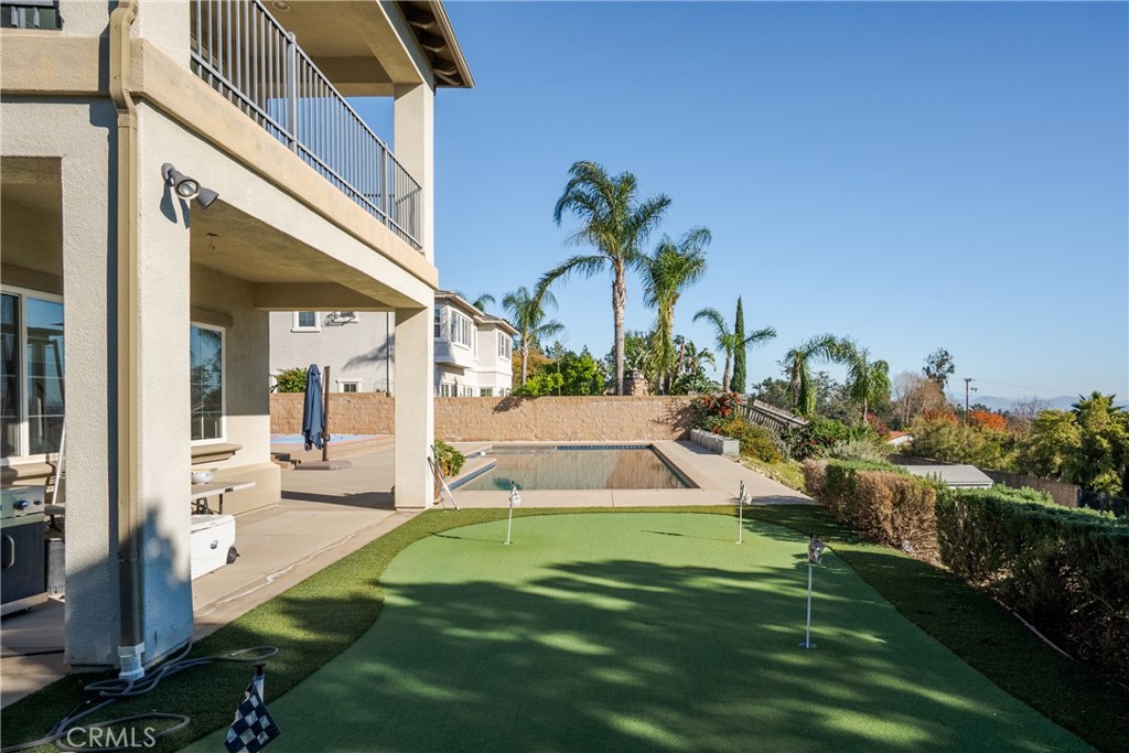 9669 Norbrook Drive Rancho Cucamonga, CA 91737 - Photo 40 of 47 a view of a backyard with couches under an umbrella