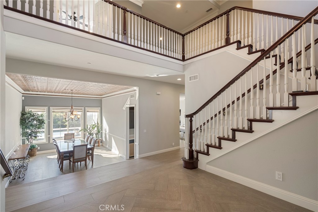 9669 Norbrook Drive Rancho Cucamonga, CA 91737 - Photo 4 of 47 a view of staircase with furniture and a large window
