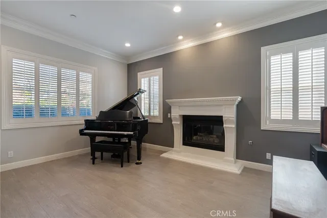 a living room with furniture a piano and a fireplace