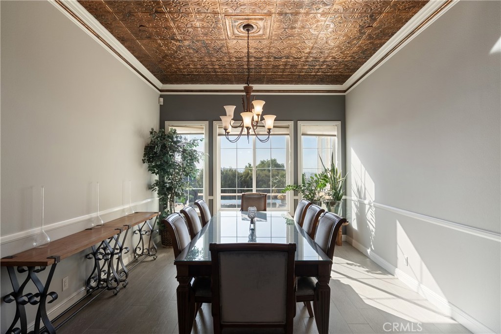 9669 Norbrook Drive Rancho Cucamonga, CA 91737 - Photo 8 of 47 a view of a dining room with furniture a chandelier and large windows