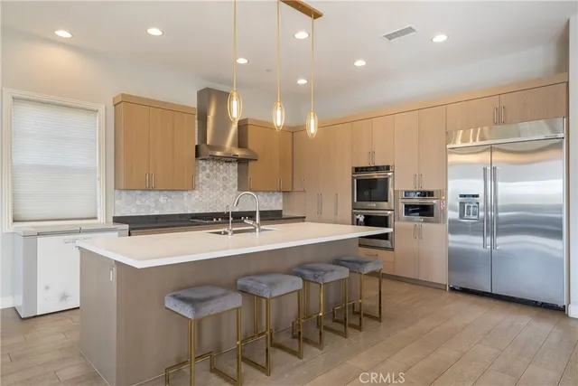a kitchen with kitchen island cabinets and refrigerator