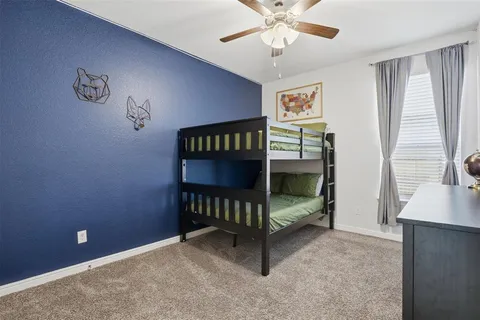 a bedroom with bunk bed and a desk