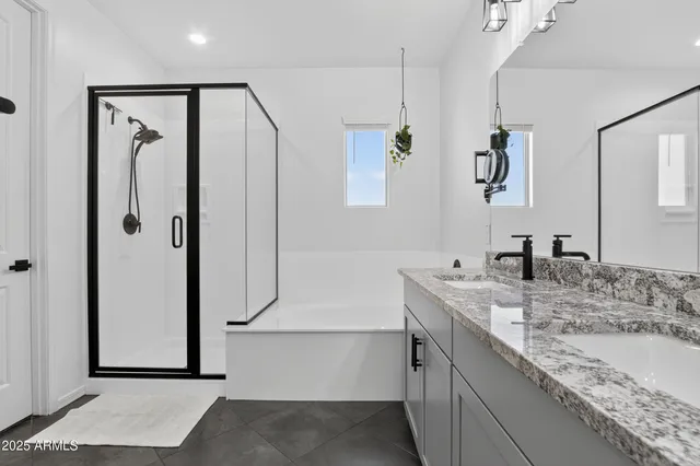 a bathroom with a granite countertop sink mirror and shower