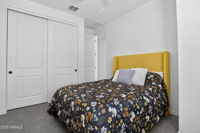 a bed sitting in a bedroom next to a bathroom