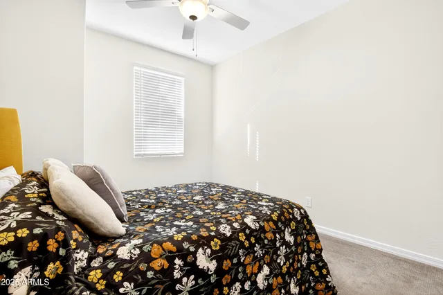 a bed sitting in a bedroom next to a window