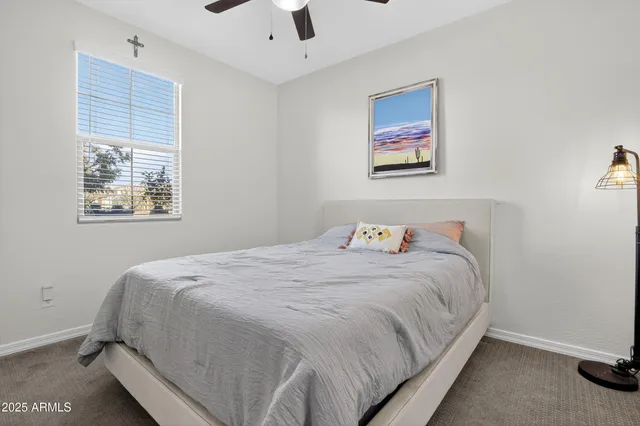 a bedroom with bed and window