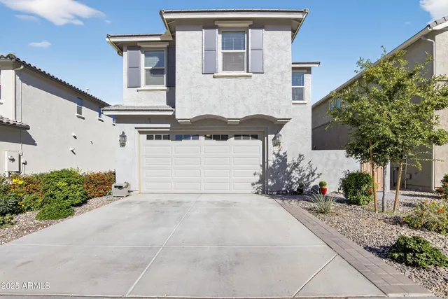 a front view of a house with a yard and outdoor seating