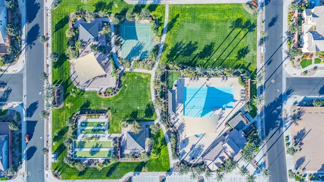 an aerial view of a house with a yard and large trees