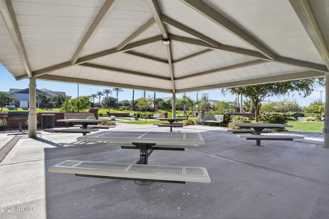 a view of a patio with a table and chairs under an umbrella