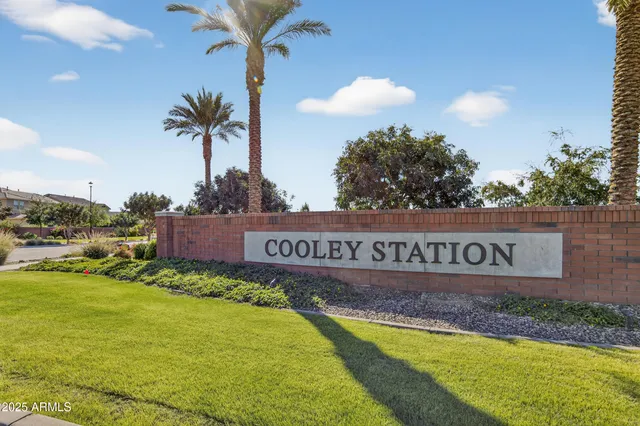 a view of swimming pool with a yard and palm trees