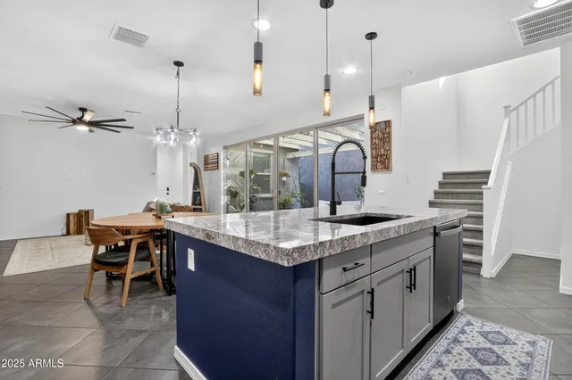 a kitchen with center island table and chairs