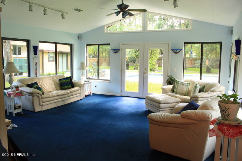 1212 Cactus Cut Road Middleburg, FL 32068 - Photo 10 of 36 a living room with furniture and a chandelier