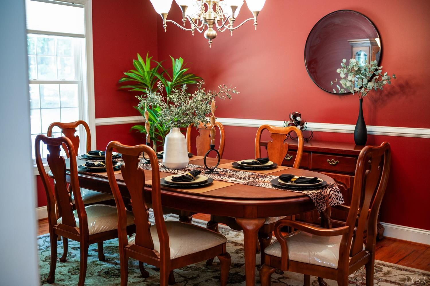 429 Matohe Road Monroe, VA 24574 - Photo 17 of 73 a dining room with furniture potted plants and wooden floor