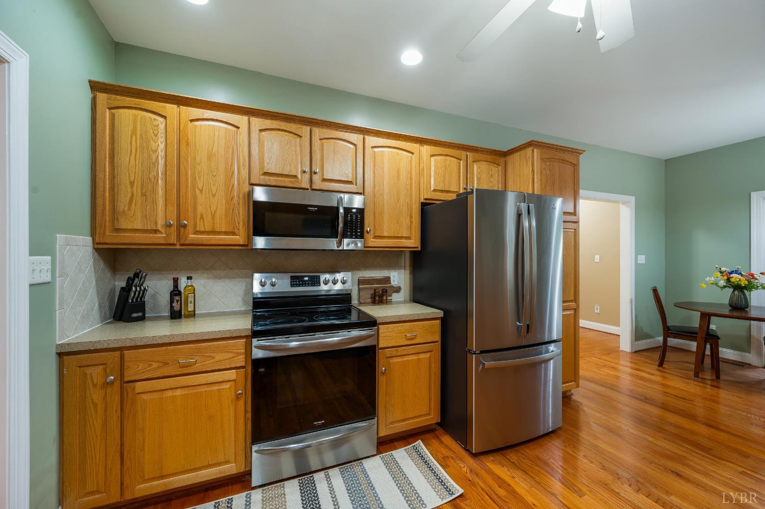 429 Matohe Road Monroe, VA 24574 - Photo 19 of 73 a kitchen with granite countertop wooden floors stainless steel appliances and a window