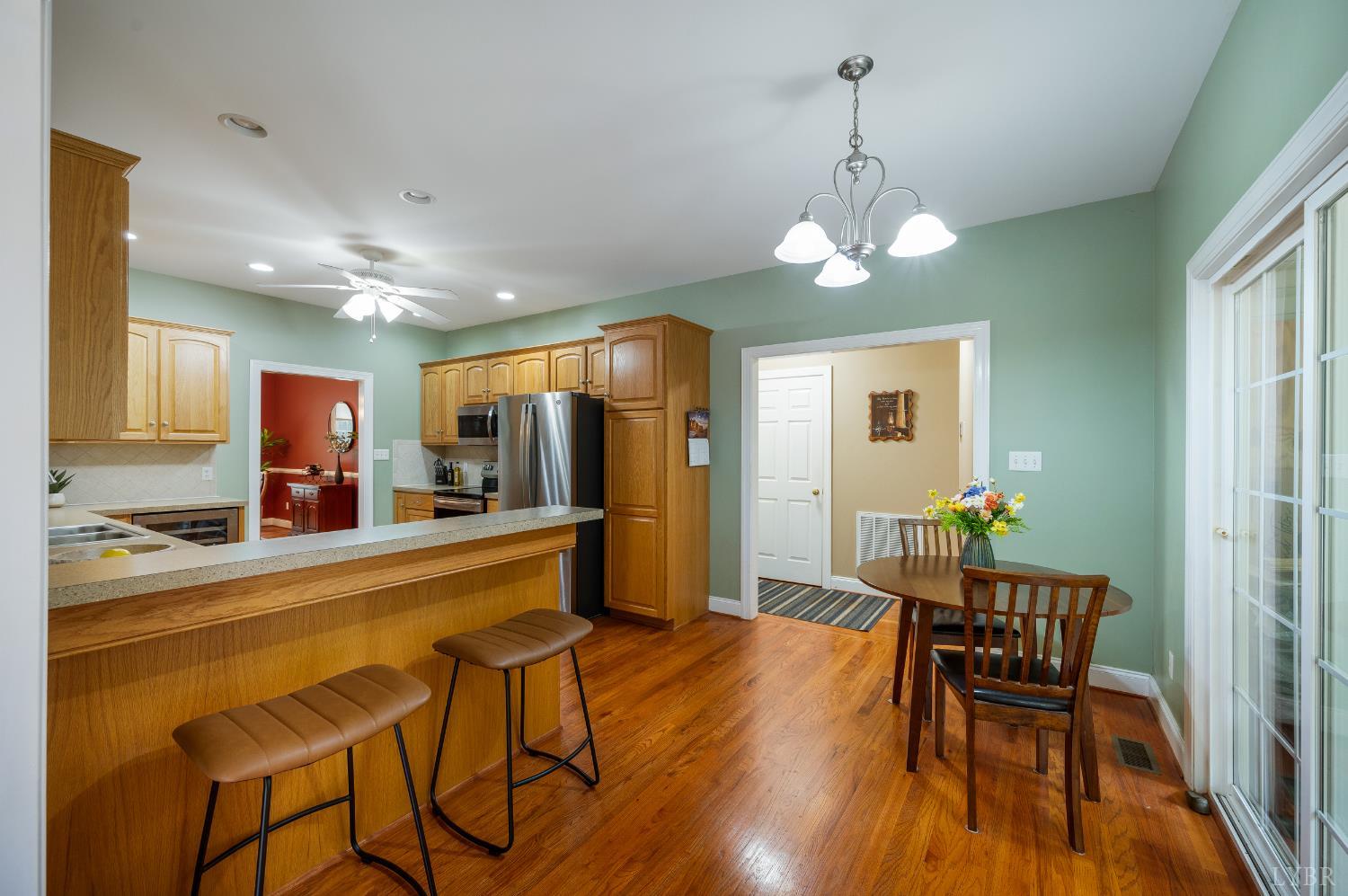 429 Matohe Road Monroe, VA 24574 - Photo 20 of 73 a dining room with wooden floor a chandelier a wooden table and chairs