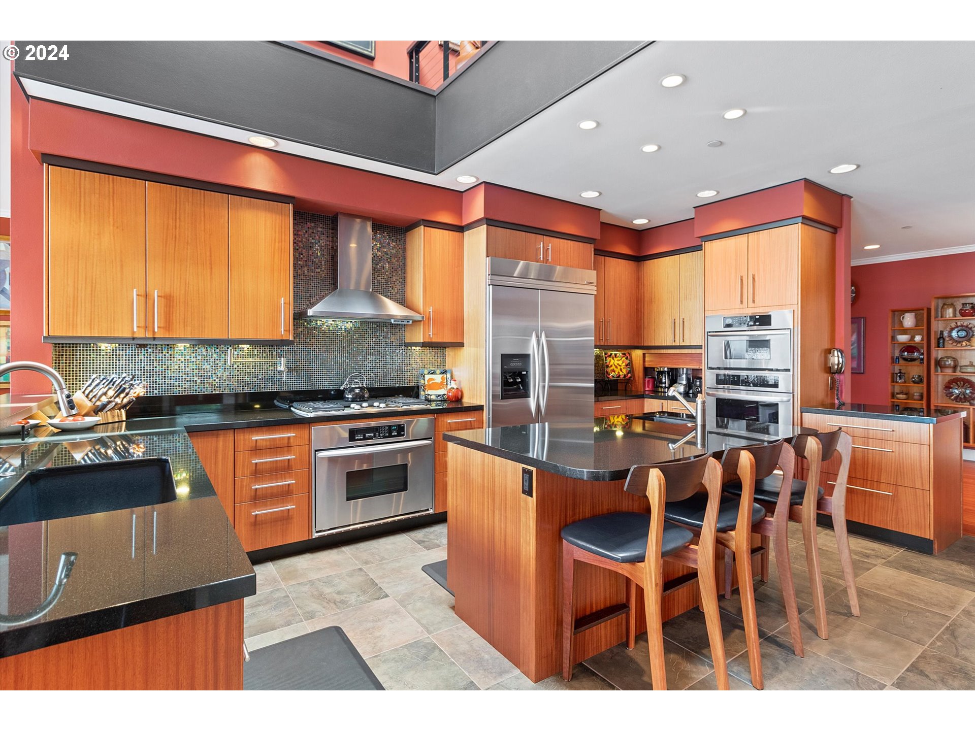 50040 South Beach Road Neskowin, OR 97149 - Photo 13 of 46 a kitchen with stainless steel appliances granite countertop a stove top oven a sink a dining table and chairs