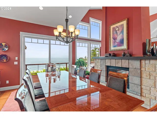 a view of a dining room with furniture a chandelier and wooden floor