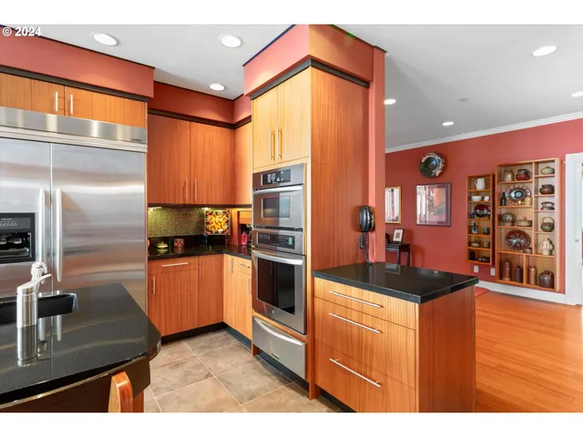 a kitchen with stainless steel appliances granite countertop a refrigerator and a stove