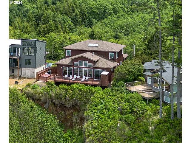 an aerial view of a house with swimming pool and garden
