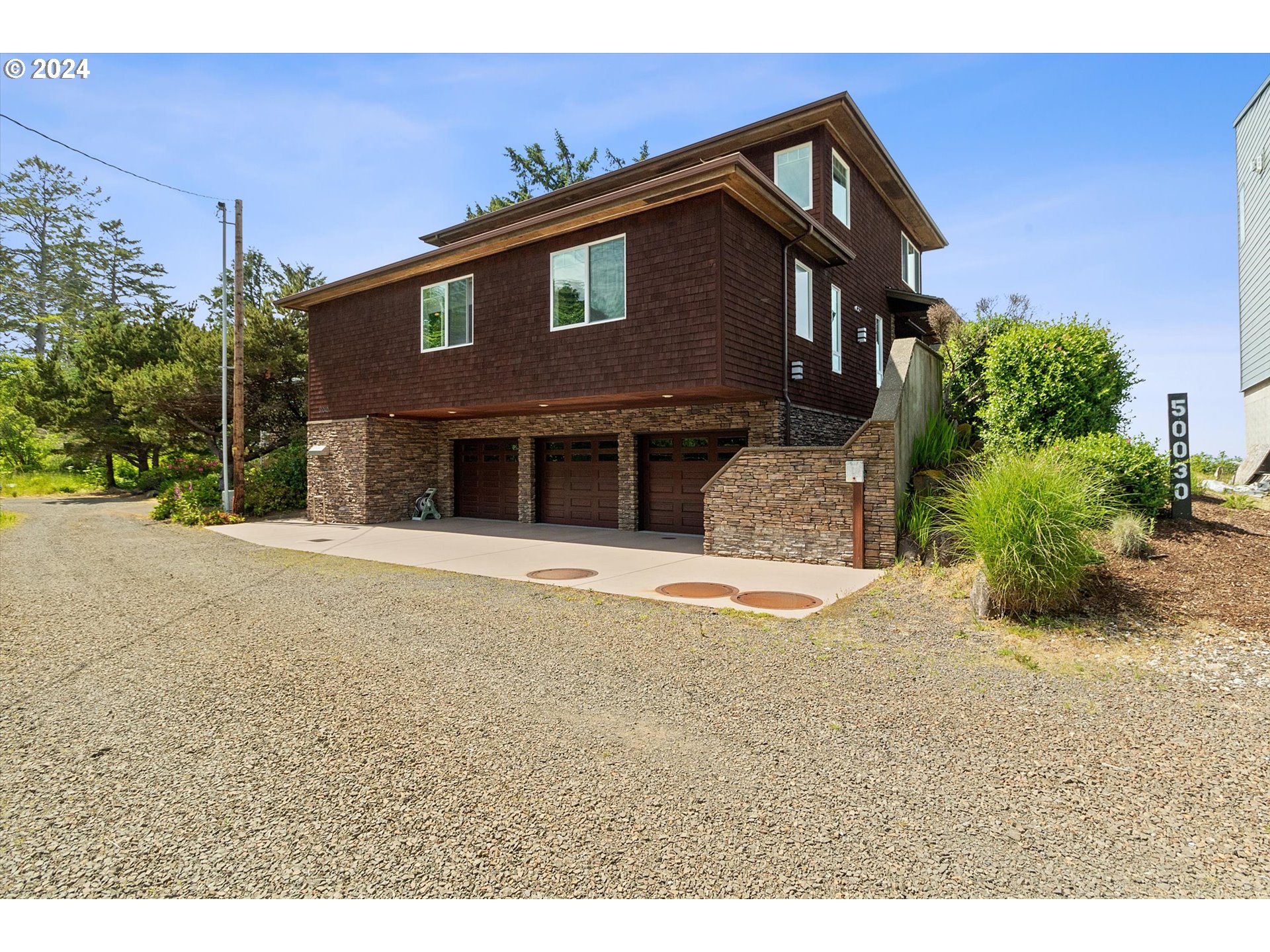 50040 South Beach Road Neskowin, OR 97149 - Photo 3 of 46 a front view of a house with a yard