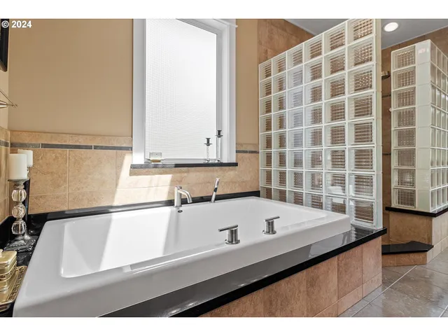 a bathroom with a shower and mirror