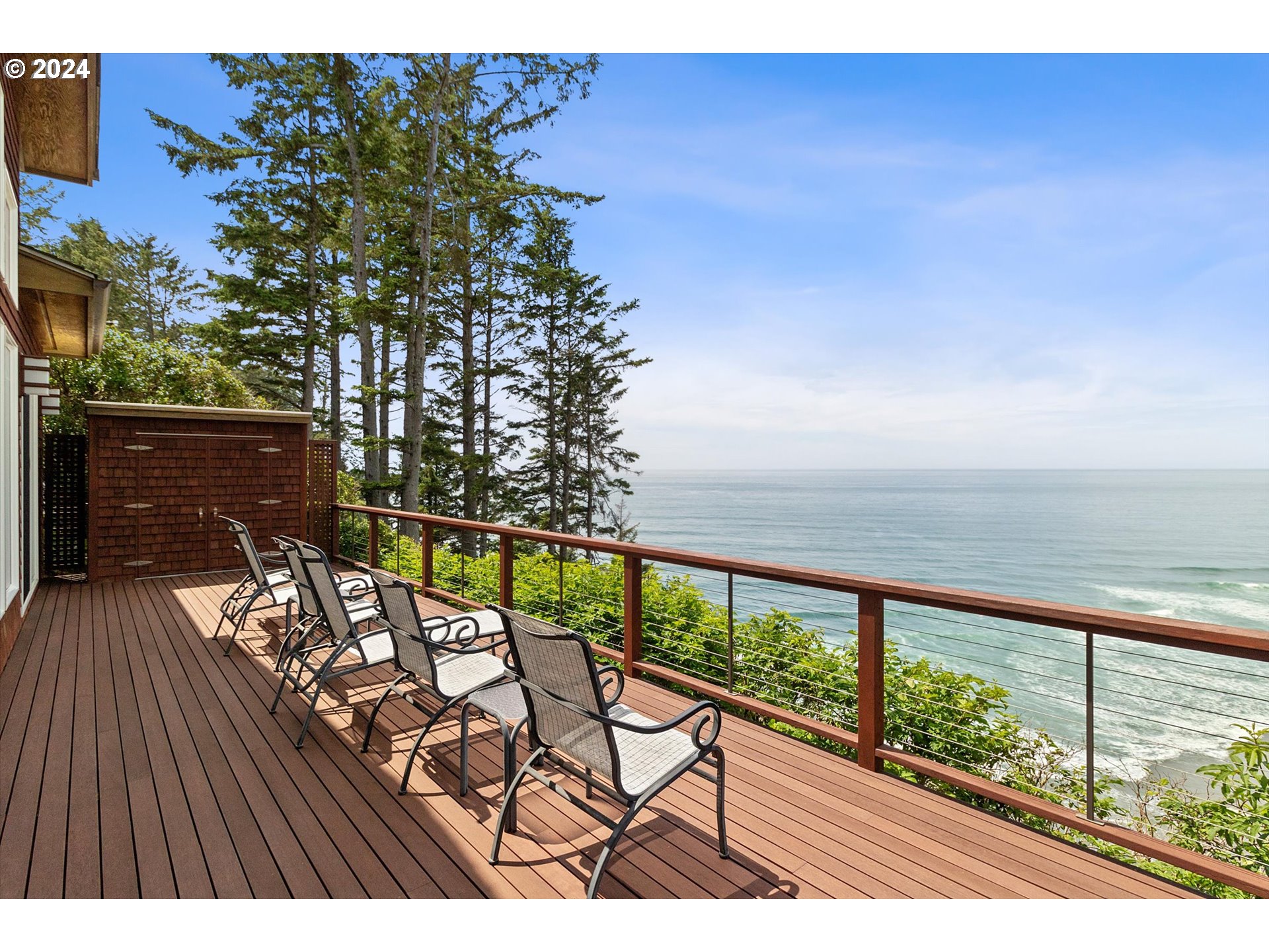 50040 South Beach Road Neskowin, OR 97149 - Photo 34 of 46 a view of a balcony with chairs and wooden floor