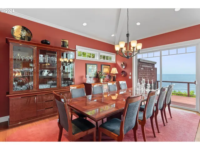 a dining room with furniture a rug and a chandelier